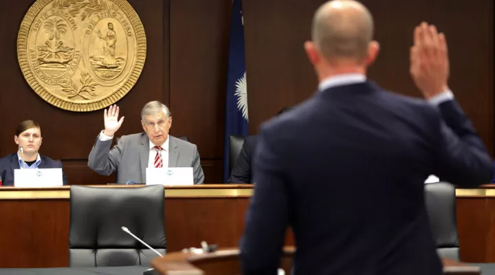 South Carolina Rep. Bill Whitmire, R-Walhalla, swears in a college trustee candidate before the College and University Trustee Screening Commission on Tuesday, March, 30, 2022, in Columbia, S.C. (AP Photo/Jeffrey Collins)
