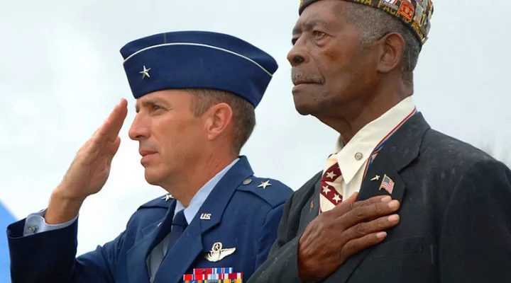 FILE - (Nov. 11, 2008) World War II veteran Harry J. Thomas, right, stands with Brig. Gen. Brett T. Williams, during the singing of the national anthem at a Veterans Day ceremony at the 18th Wing headquarters at Kadena Air Base, Okinawa, Japan.