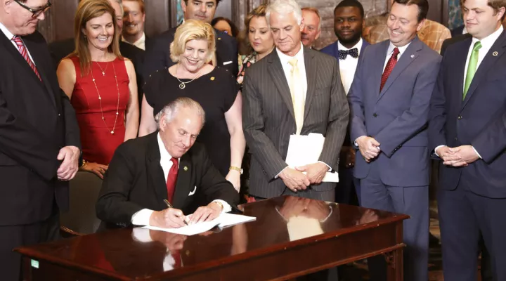 South Carolina Gov. Henry McMaster ceremonially signs a bill allowing early voting in the state on Wednesday, May 18, 2022, in Columbia, S.C. (AP Photo/Jeffrey Collins)