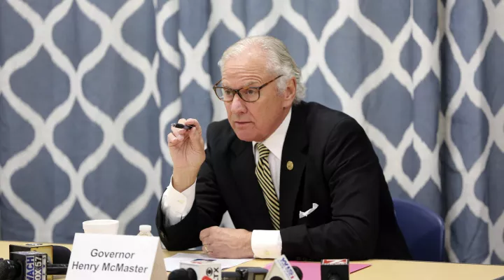 FILE - South Carolina Gov. Henry McMaster looks at data about the COVID-19 spread in the Kershaw County School District during a discussion with school officials at Camden Elementary School on Wednesday Sept. 15, 2021, in Camden, S.C. McMaster has quietly signed into law a bill, Monday, May 16, that would ban transgender students from playing girls’ or women’s sports in public schools and colleges as the state joins about a dozen others that have passed similar laws in the past two years . (AP Photo/Jeffre…