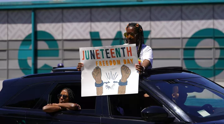 People hold a rally to celebrate Juneteenth commemoration in Inglewood, Calif., on Sunday, June 19, 2022. (AP Photo/Damian Dovarganes)