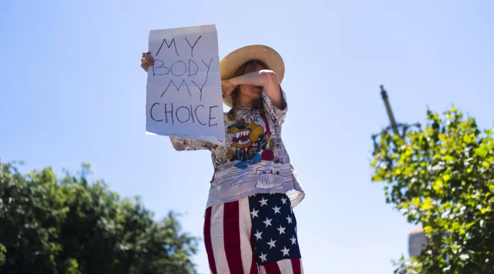 Abortion-rights advocate Eleanor Wells, 34, wipes her tears during a protest in Los Angeles, Friday, June 24, 2022. The U.S. Supreme Court's decision to end constitutional protections for abortion has cleared the way for states to impose bans and restrictions on abortion — and will set off a series of legal battles. (AP Photo/Jae C. Hong)