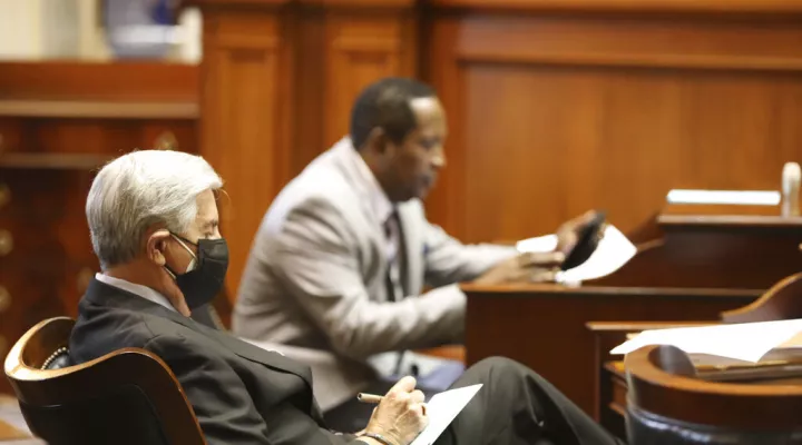 South Carolina Sen. Nikki Setzler, D-West Columbia, left, and Sen. Darrell Jackson, D-Hopkins, right, take notes as the Senate debates the governor's budget vetoes on Tuesday, June 28, 2022, in Columbia, S.C. (AP Photo/Jeffrey Collins)