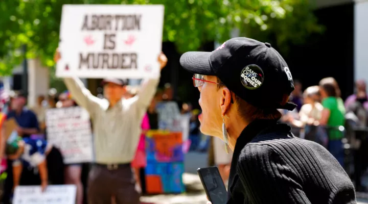 A woman supporting abortion rights shouts at anti-abortion protesters outside the South Carolina Statehouse on Thursday, July 7, 2022, in Columbia, S.C. Protesters clashed outside a legislative building, where lawmakers were taking testimony as they consider new restrictions on abortion in the wake of the U.S. Supreme Court's decision overturning of Roe v. Wade. (AP Photo/Meg Kinnard)