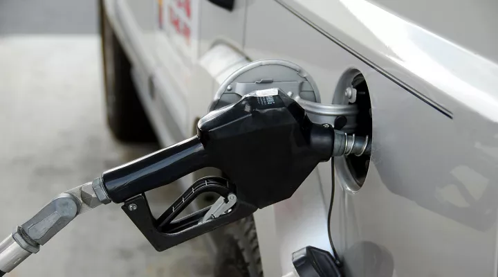  A nozzle filling up a vehicle with gas