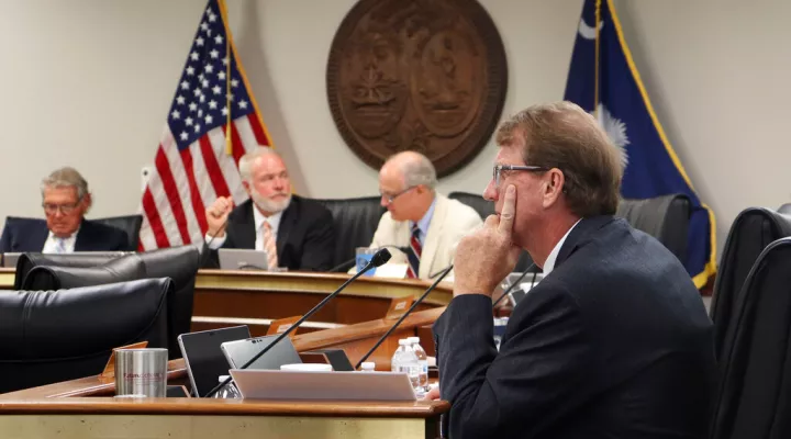 State Sen. Richard Cash, center, a leading supporter of South Carolina's recently implemented Fetal Heartbeat law banning abortion around six weeks, sits during a Senate Medical Affairs Committee meeting, Wednesday, Aug. 17, 2022, in Columbia, S.C. (AP Photo/James Pollard)