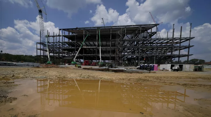  Workers at the planned Carolina Panthers site in 2021. Construction never got much past this point before the project was terminated.