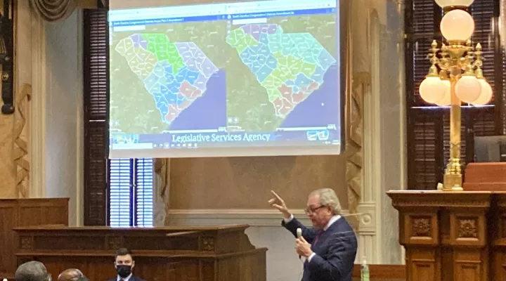 State Sen. Dick Harpootlian, D-Columbia, compares his proposed map of U.S. House districts drawn with 2020 U.S. Census data to a plan supported by Republicans on Thursday, Jan. 20, 2022, in Columbia, S.C.. The full Senate was debating the maps. (AP Photo/Jeffrey Collins)