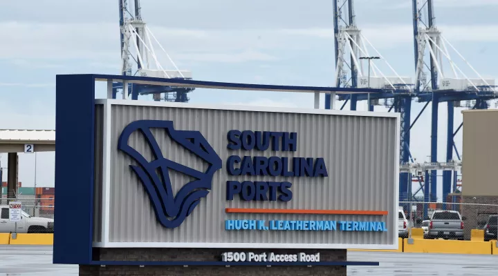 FILE - A sign marks the site of a new South Carolina Ports Authority terminal named for longtime state Sen. Hugh Leatherman on Monday, Oct. 25, 2021, in North Charleston, S.C. Work has finished on deepening the ship channel leading to the port to 52 feet so the world's largest ships can continue to dock there. (AP Photo/Meg Kinnard, File)