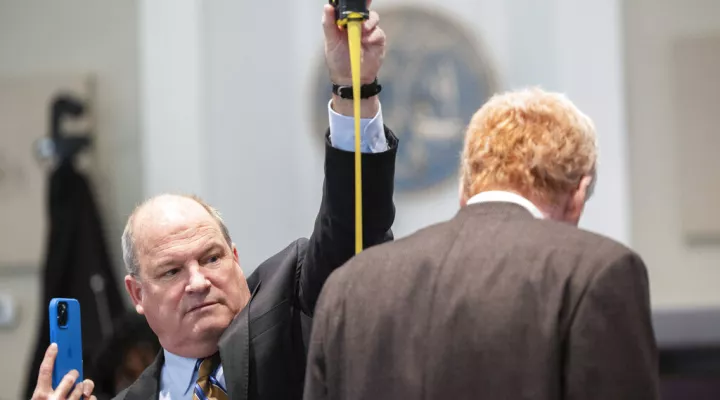 Defense attorney Jim Griffin measures Alex Murdaugh during a break in his double murder trial at the Colleton County Courthouse on Thursday, Feb. 16, 2023, in Walterboro, S.C. The 54-year-old attorney is standing trial on two counts of murder in the shootings of his wife and son at their Colleton County home and hunting lodge on June 7, 2021. (Joshua Boucher/The State via AP, Pool)