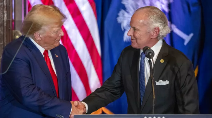 Former President Donald Trump, left, shakes hands with South Carolina Gov. Henry McMaster at a campaign event at the South Carolina Statehouse, Saturday, Jan. 28, 2023, in Columbia, S.C. (AP Photo/Alex Brandon)