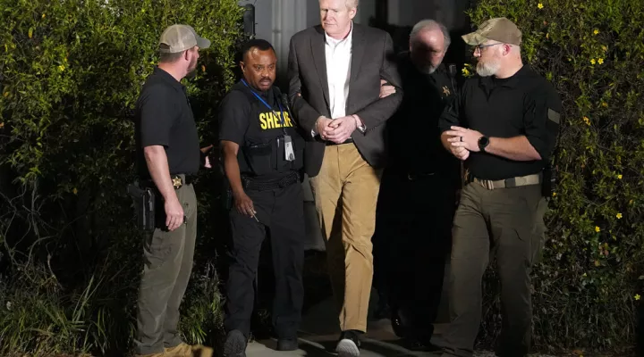 Alex Murdaugh , center, is led out of Colleton County Courthouse by sheriff's deputies after being convicted Thursday, March 2, 2023, in Walterboro, S.C. Murdaugh was found guilty Thursday on two counts of murder in the shooting deaths in June 2021 of his wife and son. (AP Photo/Chris Carlson)