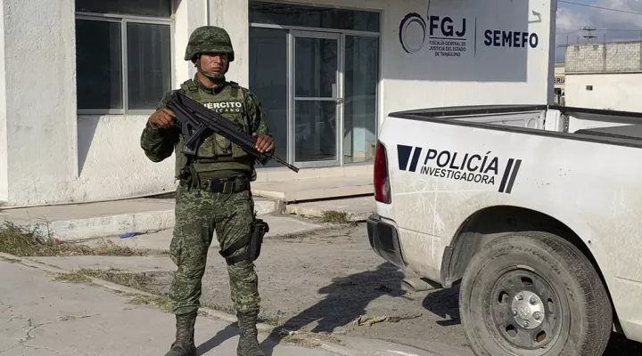 A Mexican army soldier guards the Tamaulipas State Prosecutor's headquarters in Matamoros, Mexico, Wednesday, March 8, 2023. A road trip to Mexico for cosmetic surgery veered violently off course when four Americans were caught in a drug cartel shootout, leaving two dead and two held captive for days in a remote region of the Gulf coast before they were rescued from a wood shack, officials said Tuesday. (AP Photo)