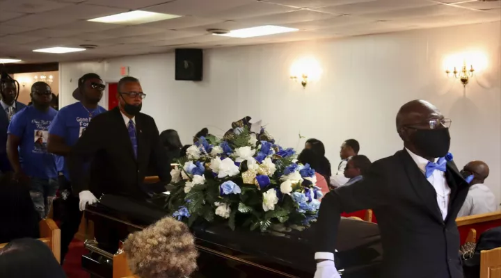 The casket is carried out of the funeral for Shaeed Woodard, in Lake City, S.C., Saturday, March 25, 2023. More than 100 people gathered to remember the man gunned down three weeks earlier by a cartel in a Mexican border city. (AP Photo/James Pollard)