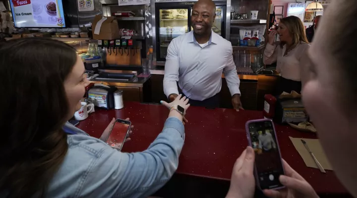 FILE - Sen. Tim Scott, R-S.C., shakes hands with diners at the breakfast counter during a visit to the Red Arrow Diner, Thursday, April 13, 2023, in Manchester, N.H. (AP Photo/Charles Krupa, File)