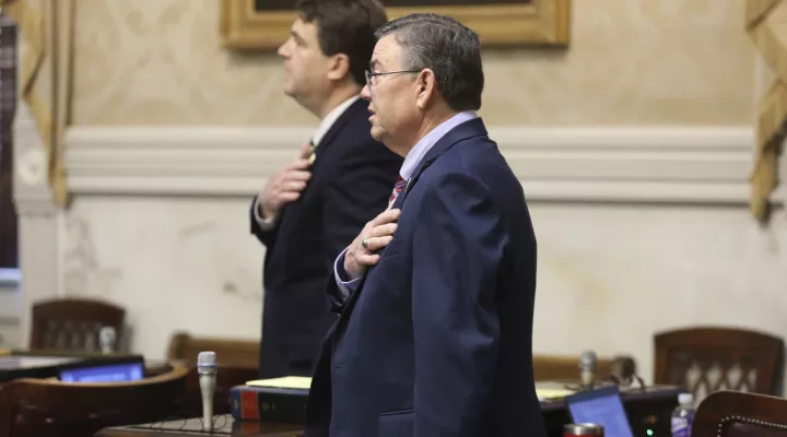 South Carolina Rep. John McCravy, R-Greenwood, foreground, and Rep. Max Hyde, R-Spartanburg, background, say the Pledge of Allegiance as the House session begins on Thursday, May 11, 2023, in Columbia, S.C. (AP Photo/Jeffrey Collins)