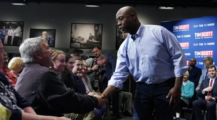 FILE - Sen. Tim Scott, R-S.C., shakes hands with a guest following a town hall, Monday, May 8, 2023, in Manchester, N.H. Scott filed paperwork with the Federal Election Commission declaring his intention to seek his party's nomination in 2024. (AP Photo/Charles Krupa, File)