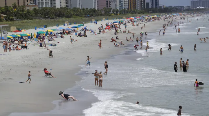 FILE - Beachgoers line the sand Thursday, July 9, 2020, in Myrtle Beach, S.C.  No one can really say definitively where the nickname “Dirty Myrtle” came from, or when it appeared. (AP Photo/Chris Carlson, File)