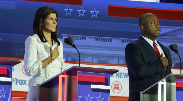 Republican presidential candidates former U.N. Ambassador Nikki Haley, and Sen. Tim Scott, R-S.C., stand on stage before a Republican presidential primary debate hosted by FOX News Channel Wednesday, Aug. 23, 2023, in Milwaukee. (AP Photo/Morry Gash)
