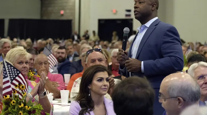 GOP presidential contender and Sen. Tim Scott, R-S.C., right, walks by Casey DeSantis, wife of GOP rival and Florida Gov. Ron DeSantis, center, as he speaks at Rep. Jeff Duncan's Faith & Freedom BBQ fundraiser on Monday, Aug. 28, 2023, in Anderson, S.C. (AP Photo/Meg Kinnard)