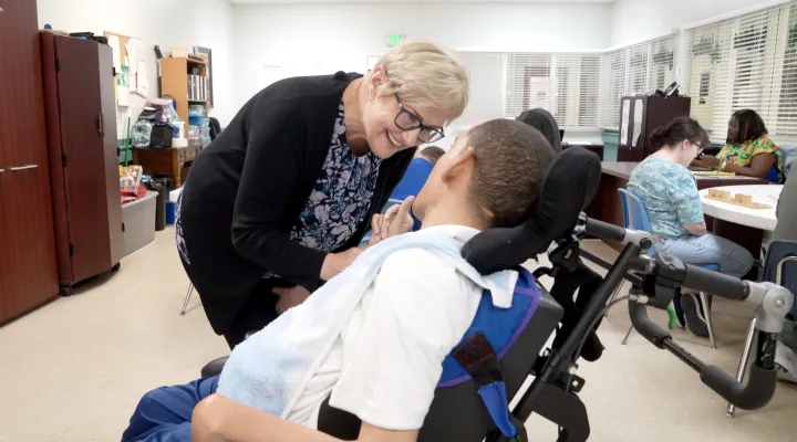  Elizabeth Krauss, Executive Director of the Georgetown Board of Disabilities and Special Needs, visits a community member at the board office.