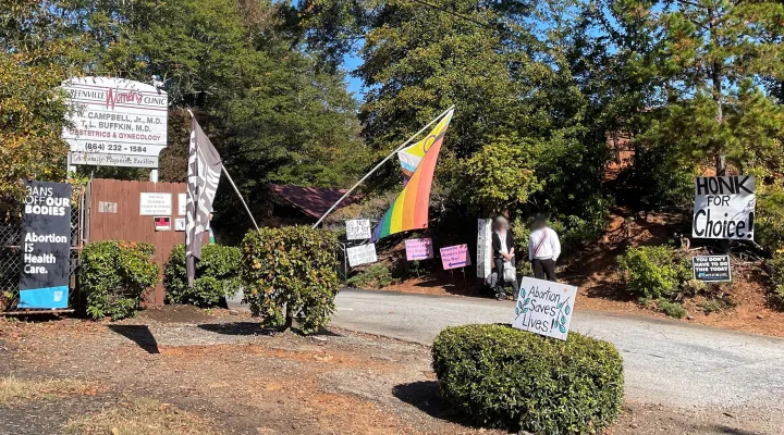  Anti-abortion demonstrators stand among flags and signs hung by those who protest for greater abortion and reproductive healthcare at the Greenville Women's Clinic. It's one of only three places in South Carolina where abortions are performed.