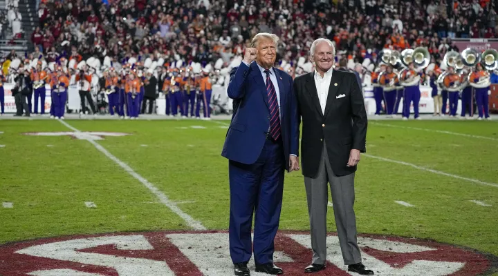 Republican presidential candidate and former President Donald Trump gestures with South Carolina Gov. Henry McMaster during halftime in an NCAA college football game between the University of South Carolina and Clemson Saturday, Nov. 25, 2023, in Columbia, S.C. (AP Photo/Chris Carlson)