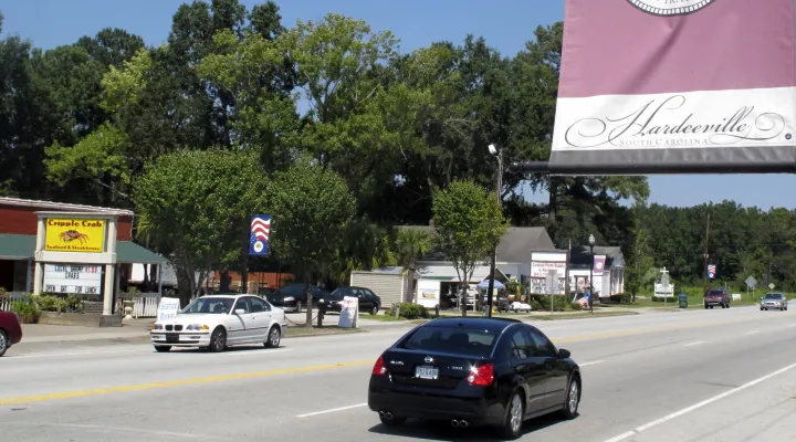 FILE - In a Sept. 15, 2010 file photo, Traffic moves through the small town of Hardeeville, S.C. Jasper County has patiently spent more than two decades inching toward a dream development: a $500 million seaport on the Savannah River that divides South Carolina and Georgia. But now the states have new governors, new port leaders and perhaps an incentive to quarrel rather than cooperate. State-run ports in both Savannah and Charleston are scrambling for federal permits and funds to deepen their harbors to m…