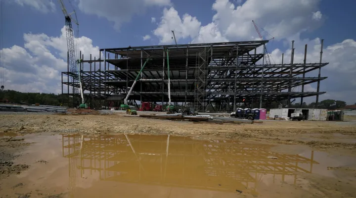 Workers at the planned Carolina Panthers site in 2021. Construction never got much past this point before the project was terminated.
