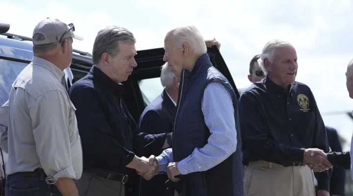 President Joe Biden shakes hands with Gov. Roy Cooper, D-N.C., with Gov. Henry McMaster, R-S.C., standing right, as he arrives at Greenville-Spartanburg International Airport in Greer, S.C., Wednesday, Oct. 2, 2024, to survey damage from Hurricane Helene. (AP Photo/Susan Walsh)