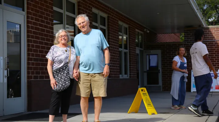 Walter Frampton (R) and his wife pose for a picture after quickly casting their ballots at Moultrie Middle School in Mount Pleasant where at lunchtime there was no line. Nov. 5, 2024.