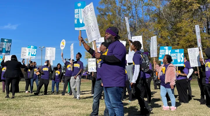 Striking workers gathered across from the main gate of Charlotte-Douglas International Airport Monday. The airport is expecting record travel this week. The workers hope the timing gets attention from the companies that employ them.