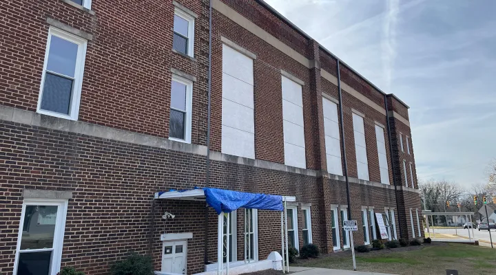 The grand windows of New Mt. Olivet AME Zion Church used to greet drivers heading into Rock Hill's historic Southside neighborhood. Since the April hailstorm, boards protect against the elements in place of the large glass panes. The church is among several properties in this end of town that are still waiting to repair damage from the hailstorm and, later, from Tropical Storm Helene.