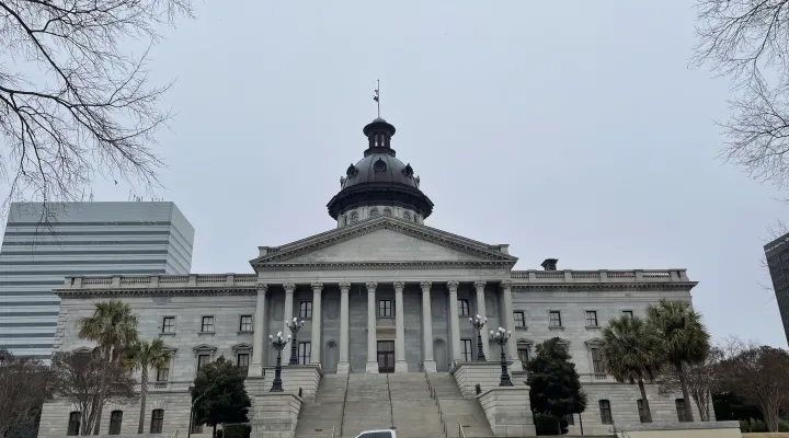 A jogger runs through snow flurries outside of the S.C. Statehouse in Columbia, South Carolina, on Tuesday, Jan. 21, 2025.