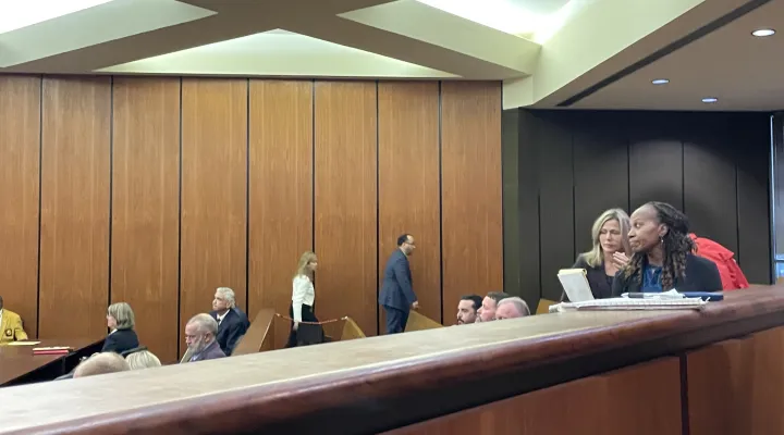 Suspended Williamsburg County Sheriff Stephen Gardner, center, walks out of his bond hearing at the Richland County Courthouse in Columbia, S.C., on Friday, March 14, 2025, as former Williamsburg County supervisor Tiffany Cooks, far right, walks over to the judge.