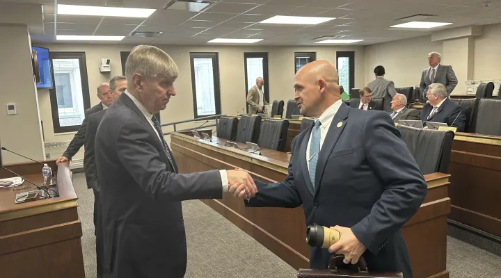 Dr. Edward Simmer, left, the nominee to be the first director of the South Carolina Department of Public Health, shakes the hand of South Carolina Sen. Tom Fernandez, R-Summerville, right, on Thursday, March 20, 2025, in Columbia, S.C. (AP Photo/Jeffrey Collins)