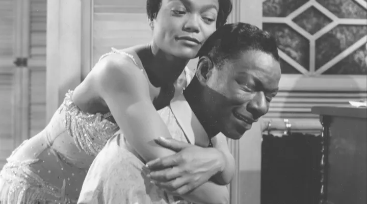 Eartha Kitt hugs Nat King Cole, playing the piano in the role of W.C. Handy, in a scene from the 1958 movie "St. Louis Blues."   (AP Photo)