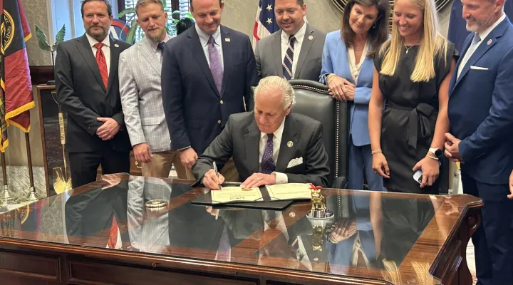 Gov. Henry McMaster signs a law criminalizing the posting of intimate photos without a person's consent on Thursday, May 29, 2025, in the governor's office in Columbia, S.C.