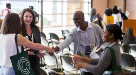 people shaking hands at a conference