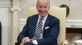 FILE - President Joe Biden smiles in the Oval Office of the White House, Sept. 16, 2022, in Washington.