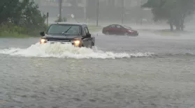 A motorist drives though high water, as another turns around during the effects from Hurricane Ian, Friday, Sept. 30, 2022, in Charleston, S.C. (AP Photo/Alex Brandon)